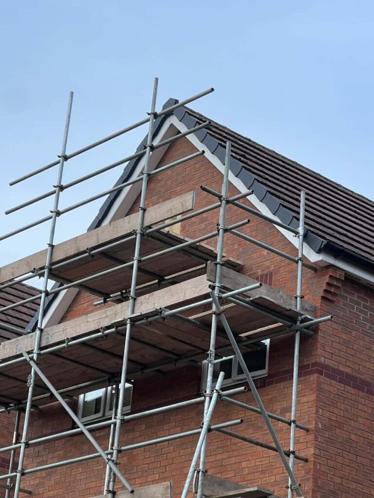 This is a photo of a roof which has just been repaired. There is a scaffold located at the gable end for access onto the roof. Works carried out by South Wigston Roofing Repairs