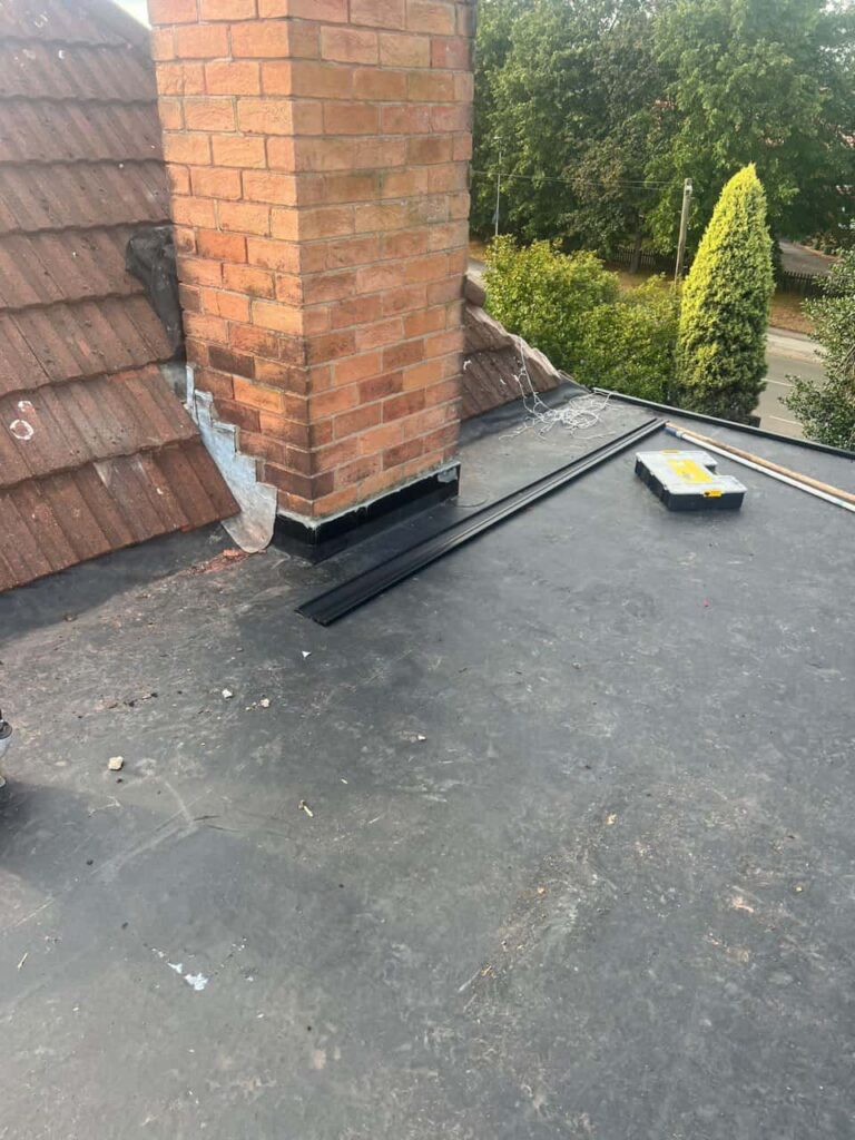 This is a photo of a flat roof which has just been repaired, there is also a chimney stack and some leadwork has also been dressed. Works carried out by South Wigston Roofing Repairs